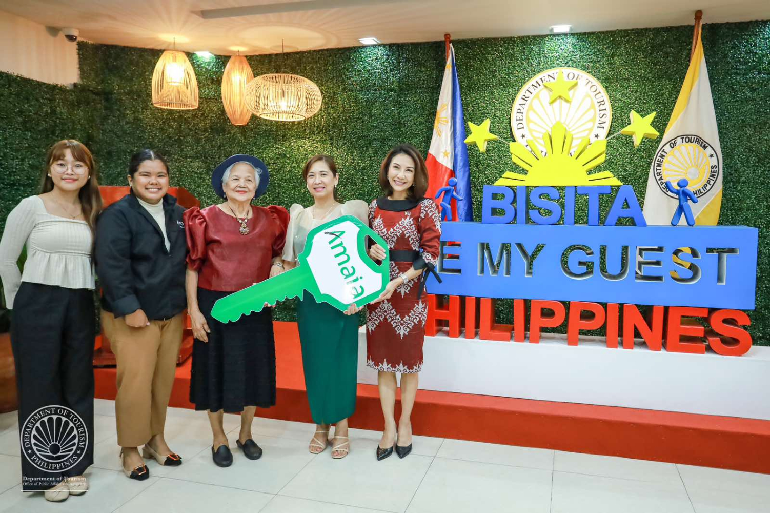 The ceremonial turnover of the Amaia house key, the grand prize of the 2nd raffle draw of the Department of Tourism’s (DOT) Bisita, Be My Guest program, was led by Secretary Christina Garcia Frasco (fifth), alongside Amaia Senior Brand Marketing Associate Fatima Villanueva (second) and Amaia South Luzon Project Marketing Associate Kathryn Dawn Abella (first). The key was presented to Fil-Am winner Helen Grace Arceo (fourth) and her mother, Salome Arceo (center).