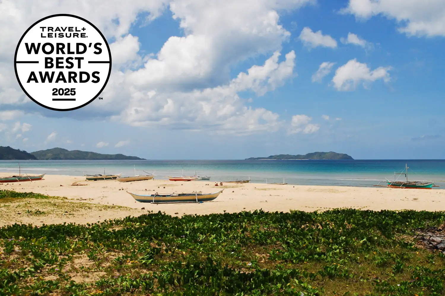 Boats sit on a white sand beach on Palawan. Jess Macdonald/Travel + Leisure